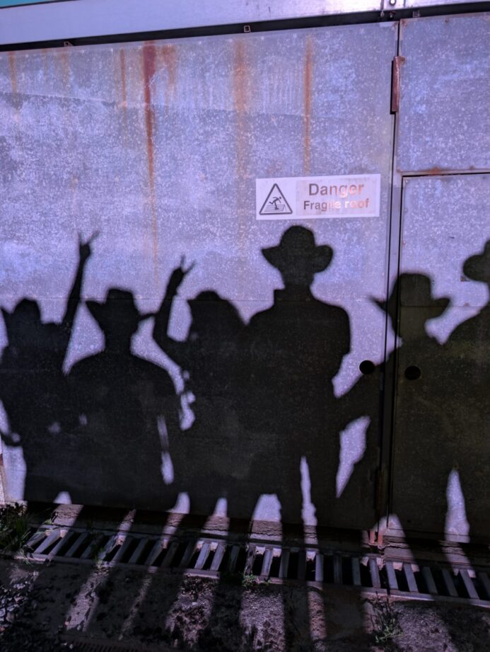 Silhouettes of The Wild Ones country band wearing cowboy hats during a UK live country music promo shoot
