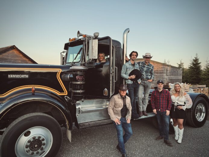 The Wild Ones country band posing with a classic Kenworth truck for a UK live country music promo shoot